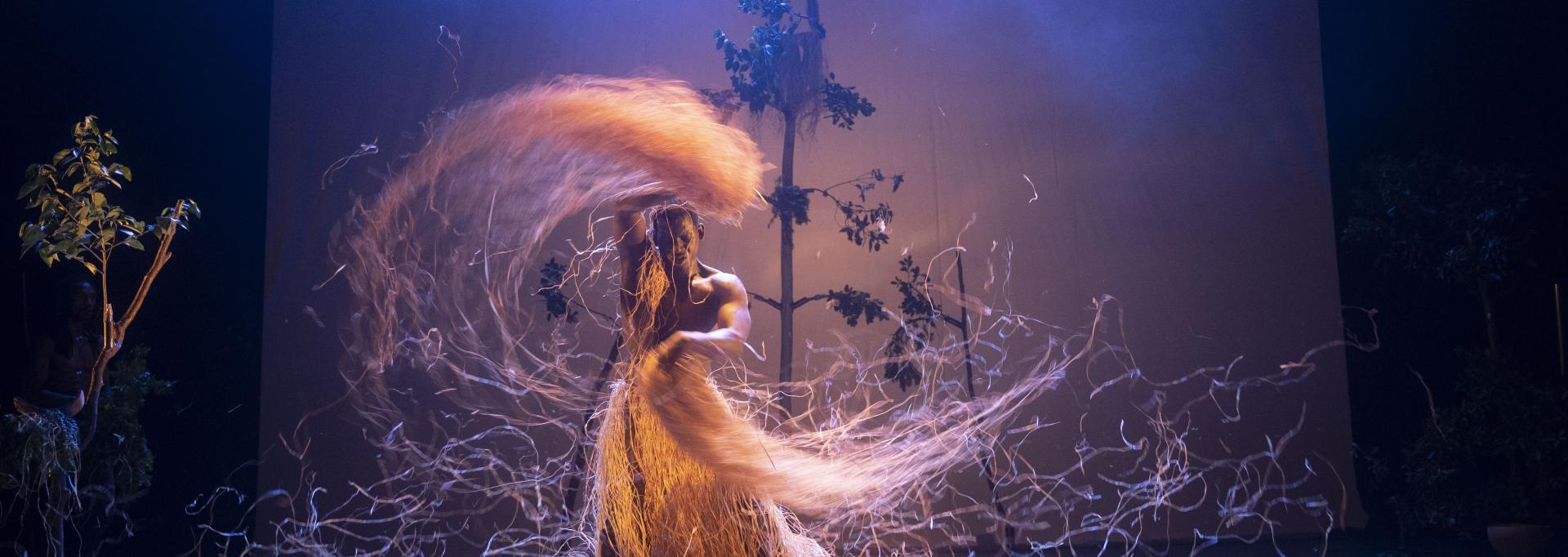 Un homme fait tourner de façon artistique de la paille