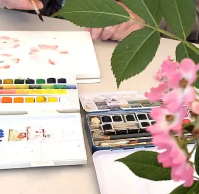 Sur une table, en premier plan à droite, un bouquet de rose sert de modèle à un peintre aquarelliste